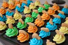 cupcakes decorated with colorful frosting on a black platter, ready to be eaten