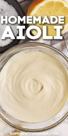 homemade aioli sauce in a glass bowl with orange slices and salt on the side