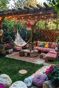 an outdoor living area with hammock and pillows