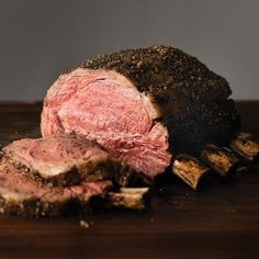 a piece of meat sitting on top of a wooden cutting board