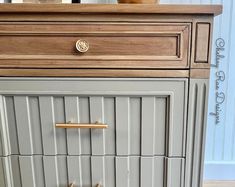 the drawers are painted gray with gold handles