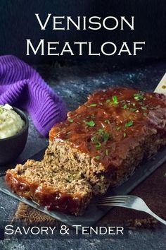 a loaf of meatloaf sitting on top of a plate next to a bowl of mashed potatoes