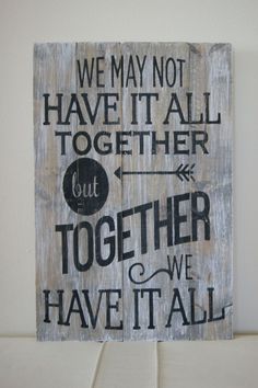 a wooden sign that says we may not have it all together but together we have it all