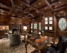 an elegant living room with wood paneling and furniture