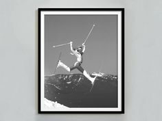 a black and white photo of a skier jumping in the air with skis on his feet