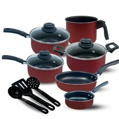 a set of pots and pans with spatulas next to them on a white background