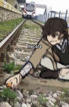 a person sitting on the ground next to train tracks with text that reads mecorre