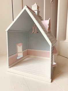 the doll house is made out of cardboard