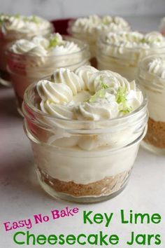 four small glass jars filled with cheesecakes on top of a white countertop