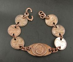 Handmade, One of a Kind, Copper Penny Bracelet with Center Oval  Raised Lincoln Penny, 6 Penny Links with dates 1973,76, 77, 81, 74, 75. Bracelet  is  8  inch long and made with Heavy Gauge Round Jump Rings. The Clasp on this 8 inch bracelet is a solid Copper Sister Hook. 8 inch, with Penny Links, Heavy Copper Jump Rings, Center is a raised Lincoln Penny on Oval, Clasp Copper Sister Hook. Some use copper Arthritis Pain. Please remember this is copper and will discolor skin which can be removed e Penny Jewelry, Penny Bracelet, Copper Penny, American Coins, Skin Discoloration, Coin Jewelry, Copper Jewelry, Remember This, Jump Rings