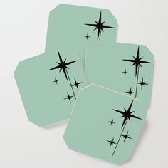 four blue coasters with black stars on them