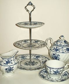 a blue and white tea set on a table