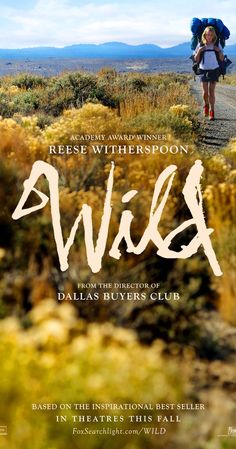 the movie poster for wild with a woman walking on a dirt road and mountains in the background