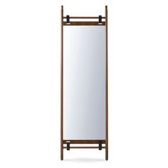 a tall mirror sitting on top of a wooden frame