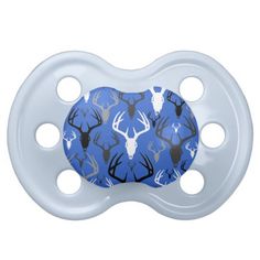 a blue and white deer pattern pacifier with two holes in the middle, on a white background