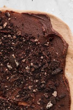 an uncooked pizza crust with chocolate toppings