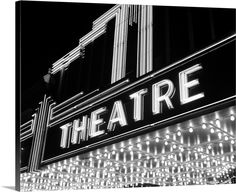 the theatre marquee lit up at night in black and white with lights all around it