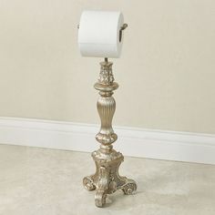 The traditional look of the Sabriel Toilet Paper Stand displays classic elegance. Finished in platinum, the resin toilet paper holder features a grand style with a pedestal base and ornate detailing. Metal bar will hold one mega roll of toilet paper. Measures 7.5"dia.x22.5"H.    This item is our exclusive!   Classic, elegant standing toilet paper holder   Features a pedestal base and ornate detailing   Holds your one mega roll of toilet paper   "/search.aspx?ss=sabriel+toilet+paper+stand"   Click Here    to view all available colors. Unique Toilet Paper Holder, Bathroom Toilet Paper Holder, Standing Toilet Paper Holder, Gold Toilet, Bathroom Toilet Paper, Copper Sink Bathroom, Toilet Paper Holder Stand, Toilet Paper Stand, Curtains Accessories