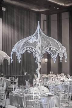 an elaborately decorated table with chairs and umbrellas