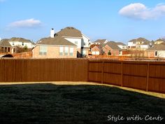 a brown fence in front of some houses