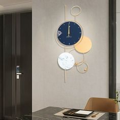 a clock mounted to the side of a wall next to a dining room table and chairs