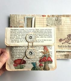 a hand holding an old book with some pictures on it and a keychain