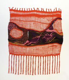 an orange piece of cloth with fringes on it and a bird sitting on the edge