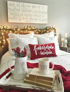 a tray with books, coffee mug and christmas lights on it in a bed room