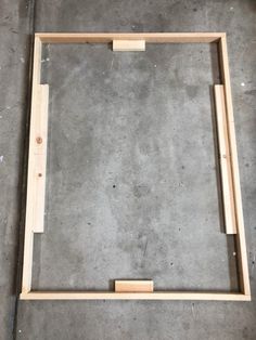 an unfinished frame sitting on top of cement