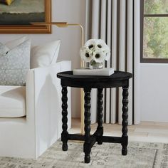 a living room scene with focus on the end table and white flowers sitting on it