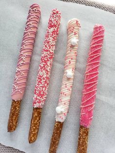 four different types of candy canes sitting on top of a piece of paper