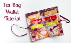 the tea bag wallet is made out of fabric and has five compartments in each compartment