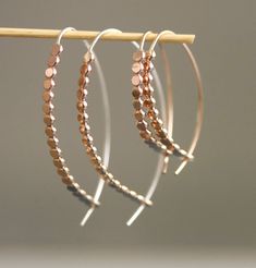 This sculptural, textured design has wonderful balance, and lives in a nice halfway point between and dangle and a hoop design. With their easy simplicity and slim lightweight profile, you'll find yourself reaching for these earrings day after day. Curved and hammered bar with dot texture with a fixed ear wire. The end of the ear wire tucks into a hole at the the bottom of the bar for extra security and visual appeal. Available in 3 sizes small: 1" medium: 1.5" and large: 2" long. Sterling silver, 14k gold fill, or mixed metal. All Rebecca Haas Jewelry is handcrafted by me in my Southern Vermont Studio from recycled and ethically sourced materials. Dot Texture, Hoop Design, Textured Design, Mixed Metals, Texture Design, Find Yourself, Ear Wire, The Ear, The Bar