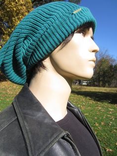 a mannequin head wearing a green knitted hat