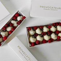 two boxes filled with raspberries and white chocolates