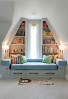 a room with some bookshelves and a couch in it's center area