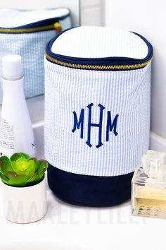 the personalized blue and white storage bag is next to a bottle of lotion