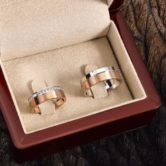 two wedding rings in a box on a table