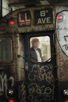 an old train with graffiti on it's side is seen from the inside window