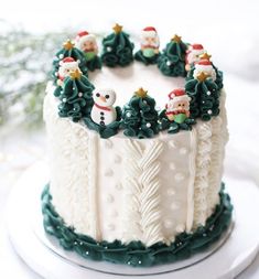 a decorated christmas cake with frosting and decorations