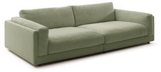 a green couch sitting on top of a white floor