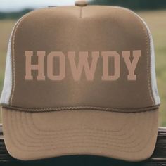 Get ready to tip your hat with our 'Howdy' Trucker Hat, perfect for both men and women! This stylish accessory comes in a classic tan and brown color scheme, featuring eye-catching, puff embossed text that adds a unique touch. Designed as an adult hat, it boasts a traditional 5-panel structure with breathable mesh sides and back for added comfort. Plus, its snapback design ensures a perfect fit for any head size. A blend of casual style and comfort, this trucker hat is ideal for everyday wear!- Classic Brown Adjustable Trucker Hat, Classic Adjustable Brown Trucker Hat, Outdoor Brown Snapback Hat With Letter Print, Adjustable Brown Trucker Hat With Letter Print, Brown Snapback Baseball Cap With Letter Print, Brown Adjustable Trucker Hat With Letter Print, Brown Snapback Cap With Letter Print, Country Style Brown Baseball Cap With Flat Brim, Brown Country Style Baseball Cap With Curved Brim