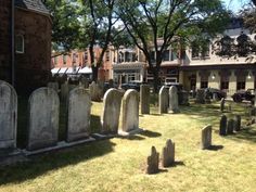 an old cemetery with many headstones in the grass