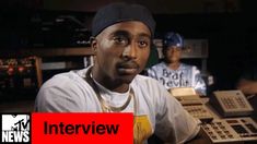 a man sitting at a desk with an interview in front of him and the caption that reads tupac talks donald & greed