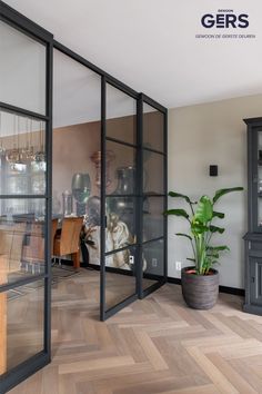 an empty room with wooden floors and glass doors