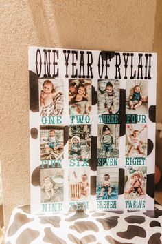 a one year of ryan sign with pictures on it sitting on a chair in front of a wall