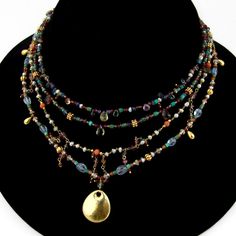 "Vintage multi-strand necklace, made of different form multi-gemstone beads with hammered oval form 18 K (.750) yellow gold pendant and toggle clasp. This outstanding necklace is 21 1/2\" long and weighs 40.6 grams. EA1418" Multi Pendant Necklace, Artisan Gold Multi-strand Beaded Necklaces, Artisan Multi-strand Gold Beaded Necklaces, Artisan Gold Multi-strand Beaded Necklace, Thrifting Manifestation, Multi Strand Beaded Necklace, Antique Jewelry Necklace, Multi Pendant, Jewelry Tattoo