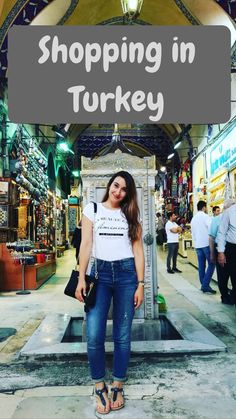 a woman standing in front of a sign that says shopping in turkey