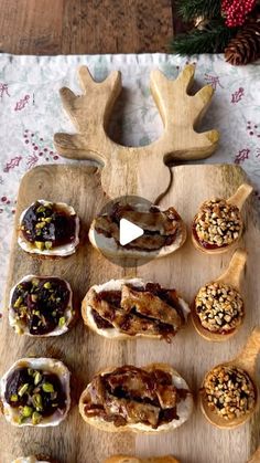 a wooden platter filled with different types of pastries on top of a table