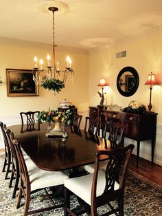 a dining room table and chairs with lights on